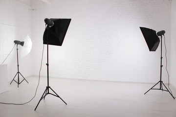 photo Studio with photo boxes against a white brick wall