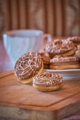 Cookies and coffee on a wooden board