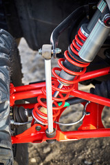 Close-up of suspension elements on an all-wheel drive ATV.
