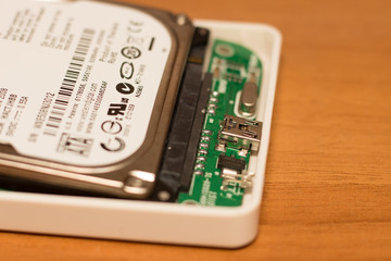 close-up view of an internal hard disk of a notebook connected to an external usb box