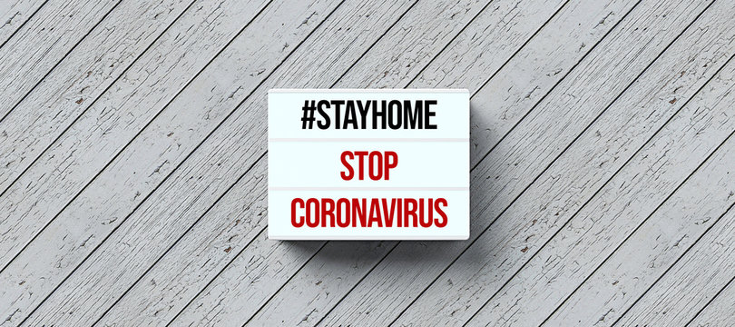lightbox with text #STAYHOME STOP CORONAVIRUS on wooden background