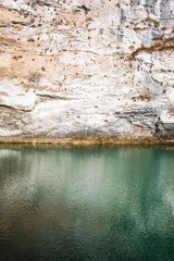 rock and lake with green water