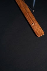 Meditation and relaxation. Item for yoga classes. Dark background, aroma wand top view, copyspace for your text