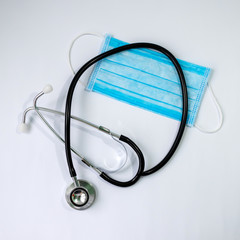stethoscope and protective bandage on face