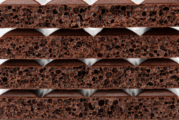 Porous dark chocolate isolated on white background.