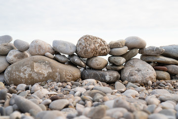 Abstract composition of pebbles stacked on top of each other on the shore