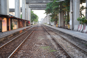 Fototapeta na wymiar blur track railway and platform train station in the evening. background.