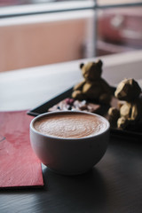 Coffee latte on vintage wood desk background