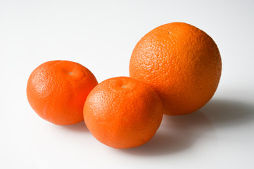 bright, juicy orange and two tangerines on a white background