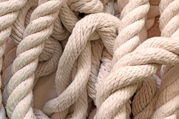 Fototapeta na wymiar white rope lying on the floor, top view.