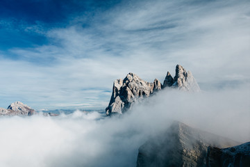 View from Seceda, Odle mountains in the fog, over the clouds. Amazing unique views in Dolomites mountains, Italy, Europe. - 331719425