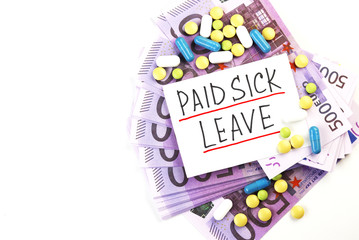 money, medical pills, and a piece of paper marked paid sick leave