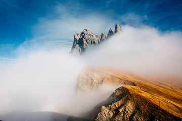 View from Seceda, Odle mountains in the fog, over the clouds. Amazing unique views in Dolomites mountains, Italy, Europe. - 331719663