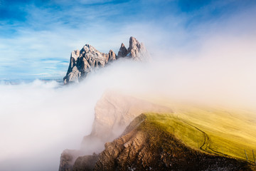 View from Seceda, Odle mountains in the fog, over the clouds. Amazing unique views in Dolomites mountains, Italy, Europe. - 331719689
