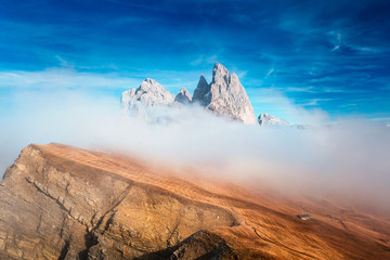 View from Seceda, Odle mountains in the fog, over the clouds. Amazing unique views in Dolomites mountains, Italy, Europe. - 331719697