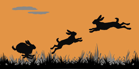 Fototapeta na wymiar realistic black silhouettes of forest hares jumping on a field on an orange background
