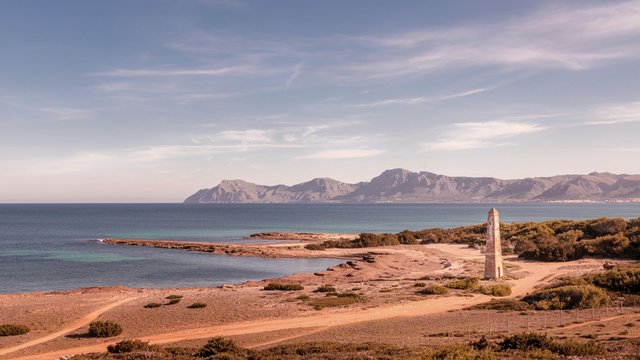 Watchtower Santa Margalida with sea and blue skies, mountains in the distance, located between Can Picafort and Son Serra De Marina,mallorca,Spain.
