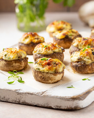 Stuffed mushrooms with cheese, delicious baked appetizer, traditional starter, golden crust.
