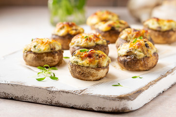 Stuffed mushrooms with cheese, delicious baked appetizer, traditional starter, golden crust.