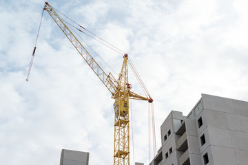 tower crane on sky background and buildings under construction