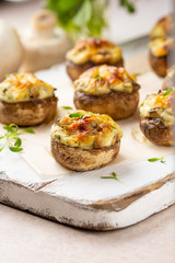 Stuffed mushrooms with cheese, delicious baked appetizer, traditional starter, golden crust.