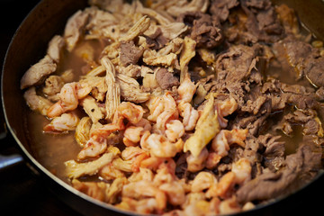 Cooking chicken, beef and shrimp 