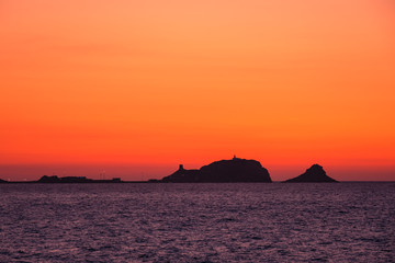 Naklejka na ściany i meble Sunset at the red rock of Ile Rousse in Corsica