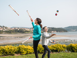 boy and girl juggling on the garden