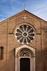 Bologna, closeup of the medieval facade of the Basilica of San Domenico (1240) in Romanesque style with the rose window and the entrance portal. Emilia-Romagna, Italy, Europe