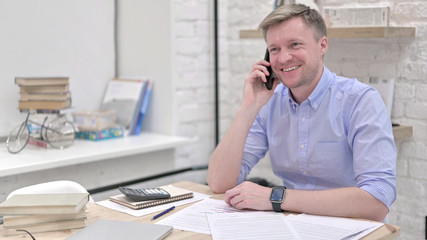 Happy Businessman Speaking on Phone and Smiling 