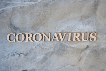 coronavirus outbreak word written on wooden letters.