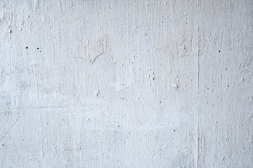 cracked white paint on concrete wall