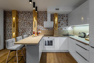 Stylish white kitchen set. Modern loft interior of studio apartment. Private house.