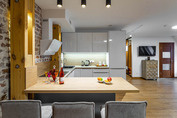 Stylish white kitchen set. Modern loft interior of studio apartment. Private house.