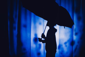 Girl Silhouette with umbrella under the rain drops