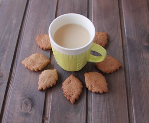cup of coffee and cookies on wooden table