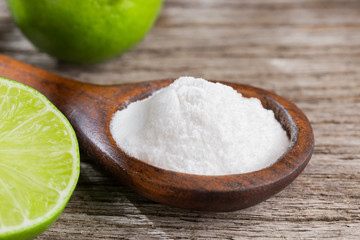 Baking soda and lemon on wooden background space for text