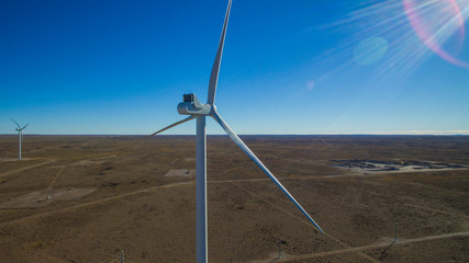 Aerial photo of windmills powered by aerofoil that provide sustainable energy.