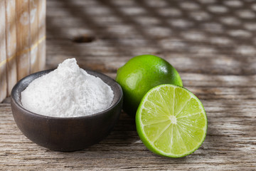 Baking soda and lemon on wooden background space for text