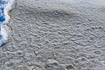 Aerial view of an ice texture floating on the waves of the Gulf of Finland