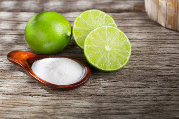 Baking soda and lemon on wooden background space for text
