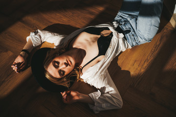 The concept of shooting in a photo Studio with hard lighting from the Windows. Sexy sensual blonde...