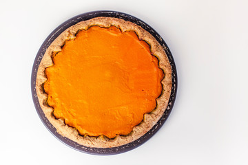 Pumpkin homemade cake on white background with open space without decorations