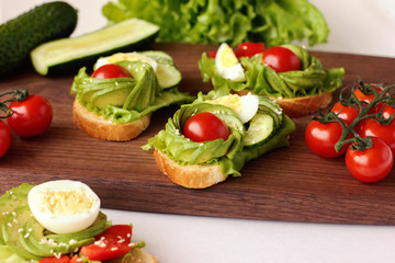  healthy breakfast sandwiches with avocado, tomato and cucumber. selective focus. healthy lifestyle concept. low carb diet.