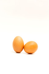 Two brown eggs isolated on white background