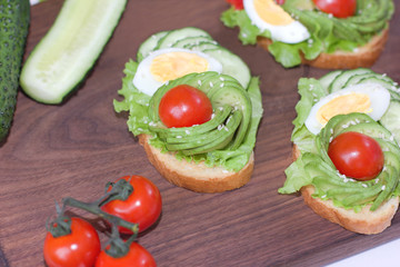  healthy breakfast sandwiches with avocado, tomato and cucumber. selective focus. healthy lifestyle concept. low carb diet.