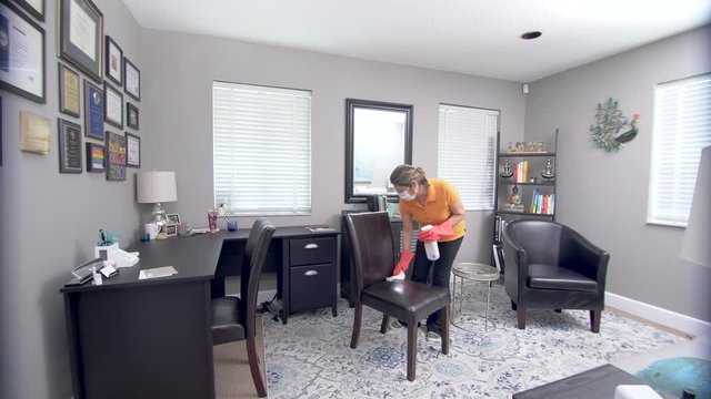 403 Cleaning lady wiping an office wearing a face mask