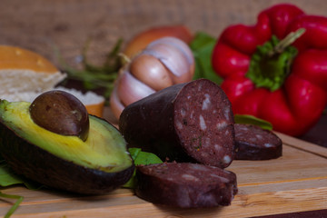 A black pudding with avocado and other vegetables