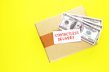 contactless delivery. parcel and money on a yellow background