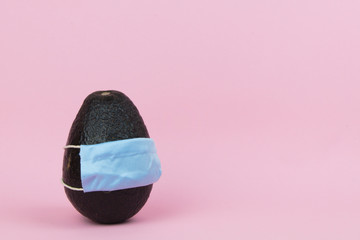 Isolated avocado wearing a surgical face mask 